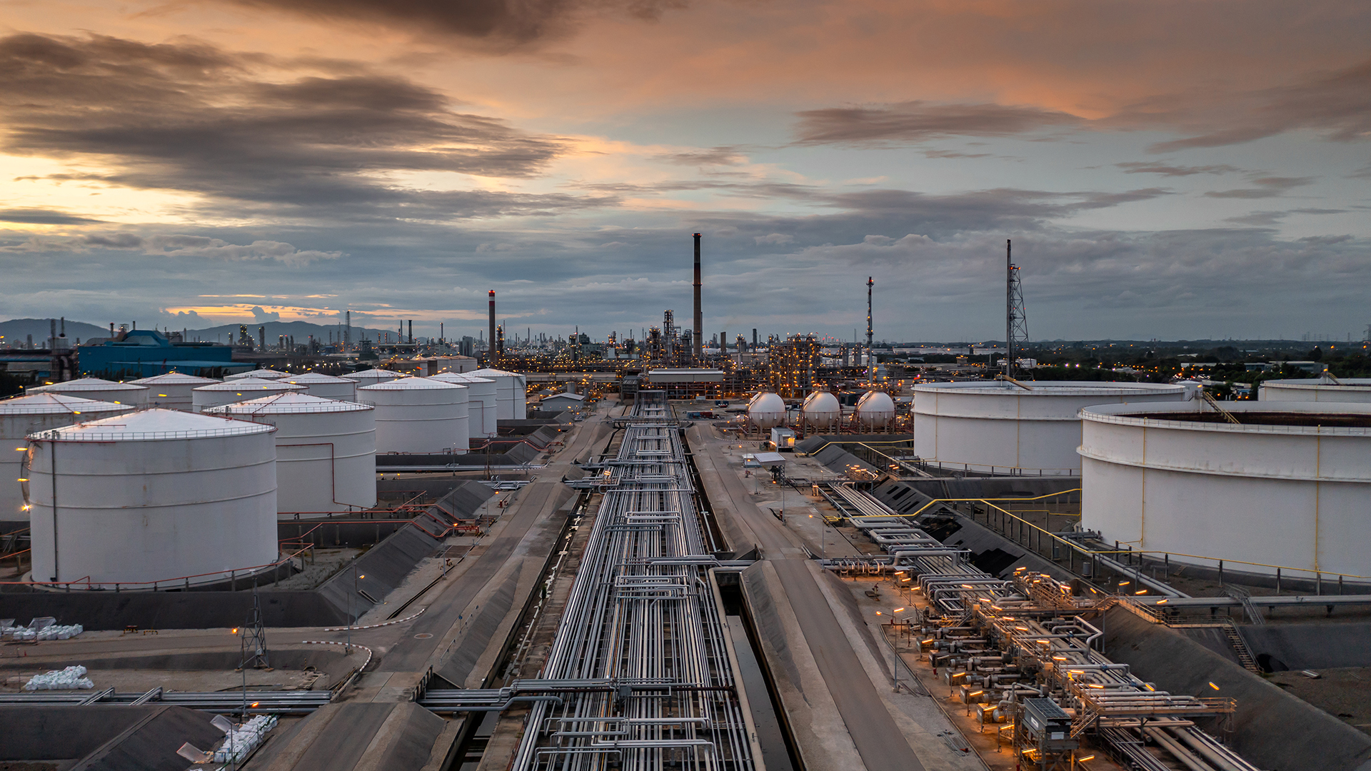 Crude oil storage tank terminal port, Oil terminal pipeline fuel storage tanks at oil refinery industrial zone in the cargo seaport and ship tanker and storage silo tank at petrochemical terminal port.
